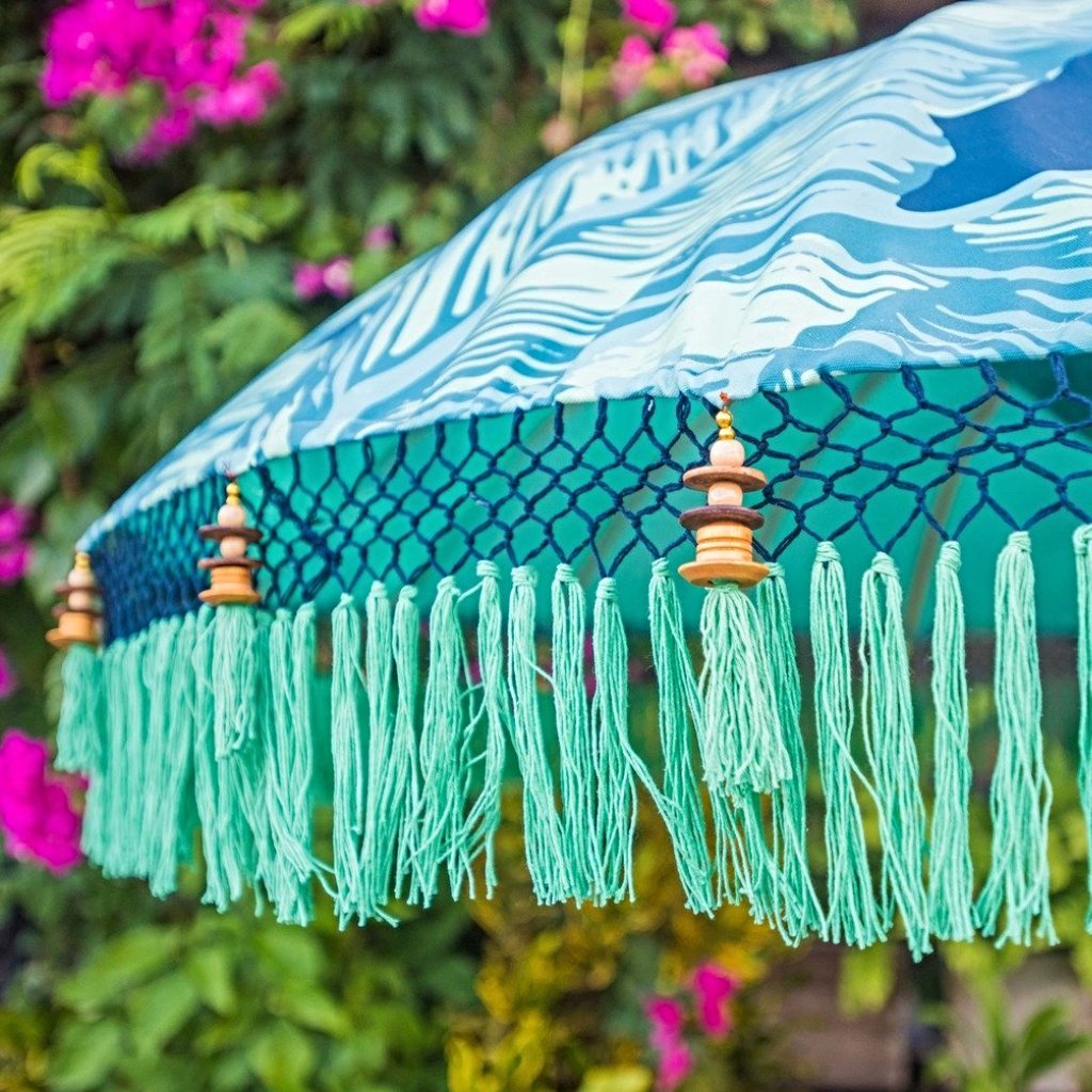 Nina parasol. Digital printed waterproof canvas dark blue palm leaf banana leaf design blue and green. East London parasol company garden umbrella made in bali. Side view