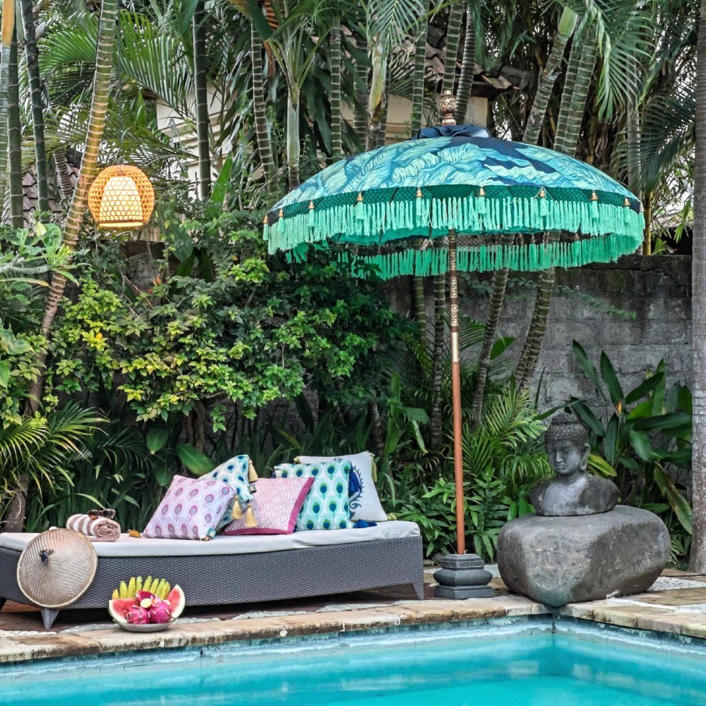Nina- Navy blue waterproof canvas Bali garden parasol with palm print and banana leaf design. Beautiful umbrella perfect for a picnic, patio, through your table with an umbrella hole or by your sun lounger at the pool. Make your outdoor space chic, elegant and glamorous with this colourful tropical jungle summer decoration. 