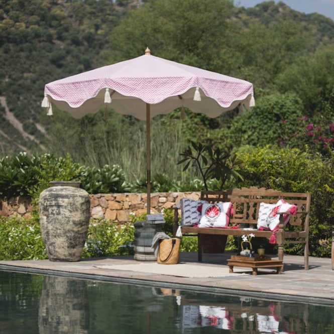Pink Aretha Octagonal Parasol lifestyle image of parasol by the pool