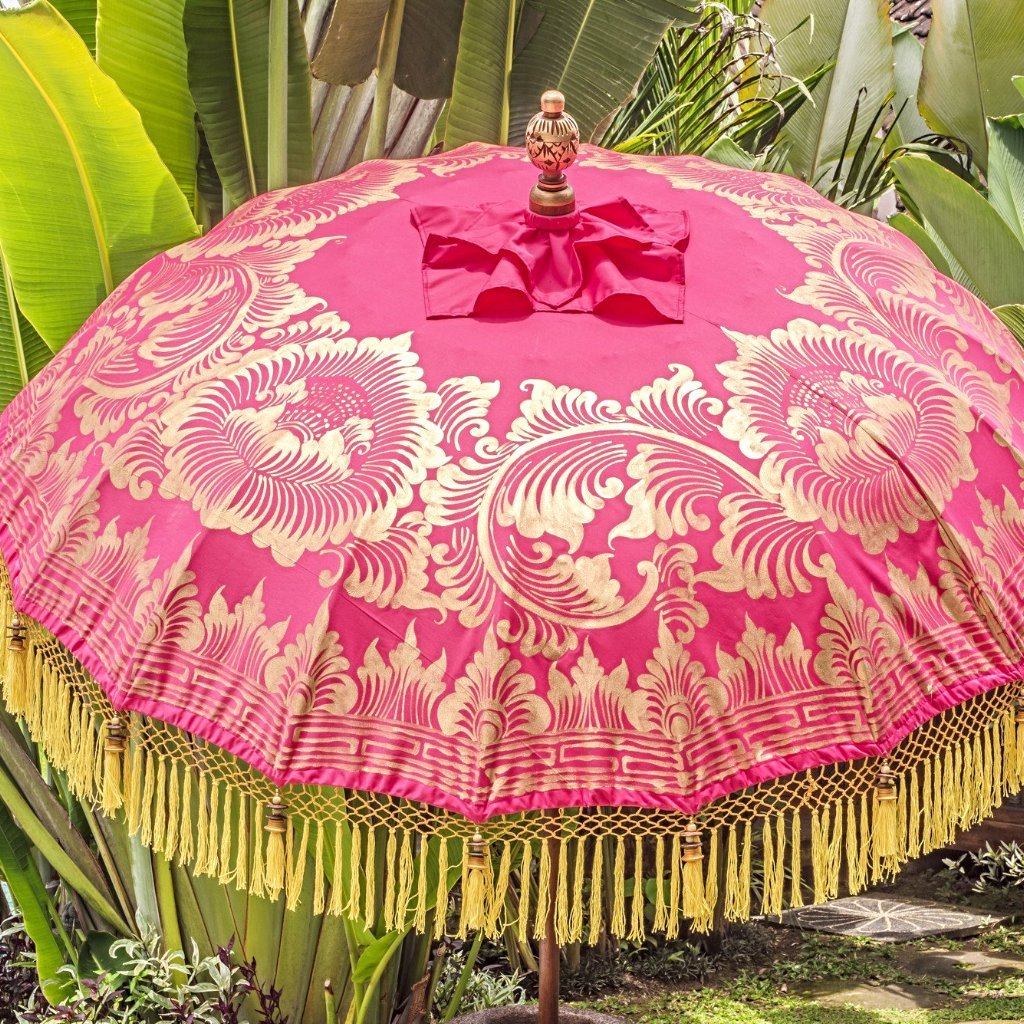 Whitney- East London Parasol Company pink Bali garden umbrella with yellow and orange tassels, pom poms and fringing. Stunning, colourful parasol for an elegant summer garden. Perfect beautiful decoration for parties, weddings alfresco dining, picnics, pool side, through a table or by a sun lounger.