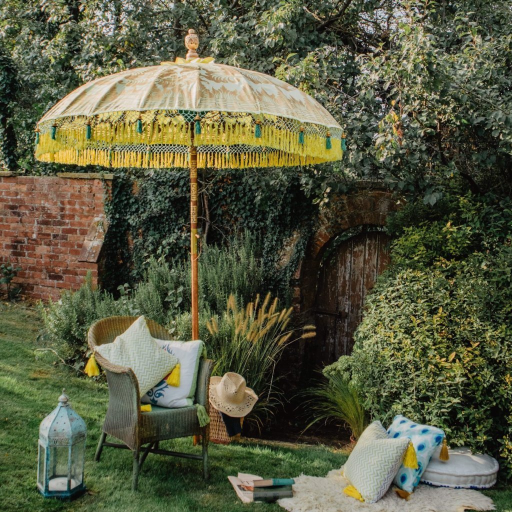 East London Parasol Company Bali Bamboo 2m garden umbrella. Goldie- yellow and gold with tassels. Handmade and handpainted with yellow and green fringing.
