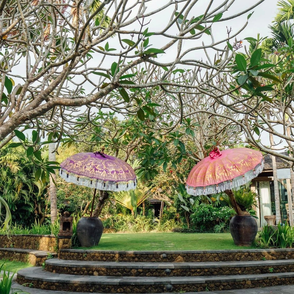 East London Parasol Heidi-  pink and gold bamboo 2m Bali garden umbrella. Tassels in shades of white and pink, hand made and artisan. The perfect decorative umbrella for picnics, summer, patios, pool side and terraces. Colourful, pretty and luxurious designer garden feature and perfect for a colourful summer party.