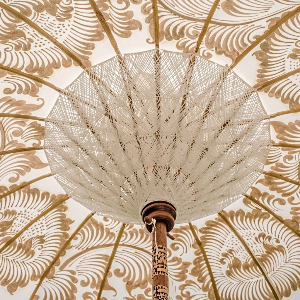 Simone- Cream white and gold garden handmade parasol with fringing pom poms and beads. A Bali umbrella perfect for a picnic, patio, through your table with an umbrella hole or by your sun lounger at the pool. Make your outdoor space chic, elegant and glamorous with this chic boho garden accessory. The most pretty and elegant garden umbrella. Luxury garden decoration for a fabulous summer.