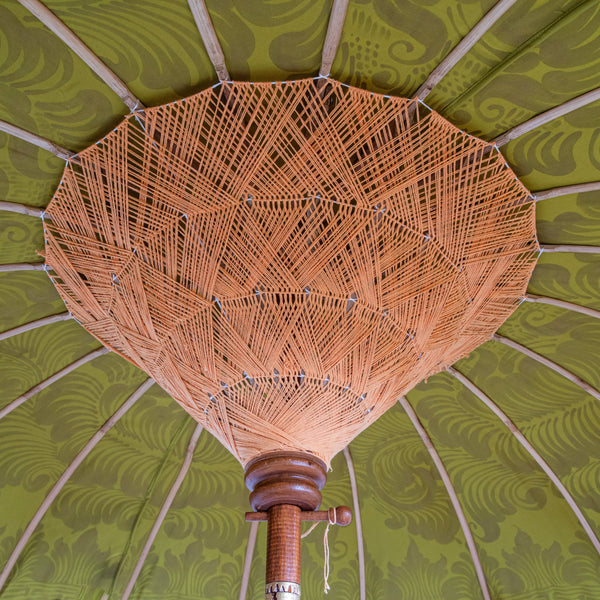 Wolfie Bamboo Parasol product shot showing olive canopy with golden lotus design