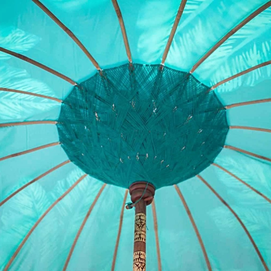 Nina parasol. Digital printed waterproof canvas dark blue palm leaf banana leaf design blue and green. East London parasol company garden umbrella made in bali. Inside view
