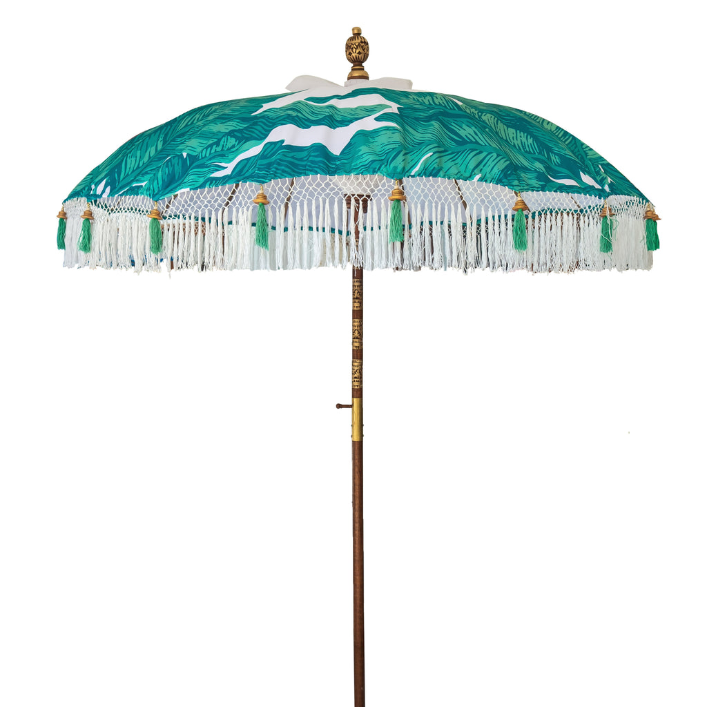 Meryl- green and turquoise palm print Bali waterproof parasol for a beautiful colourful garden. The most luxurious garden umbrella for a pretty pool side, bistro cafe table, deck chair and picnic. Flamboyant and stylish jungalow style tropical summer accessory. A pretty decoration for alfresco dining.