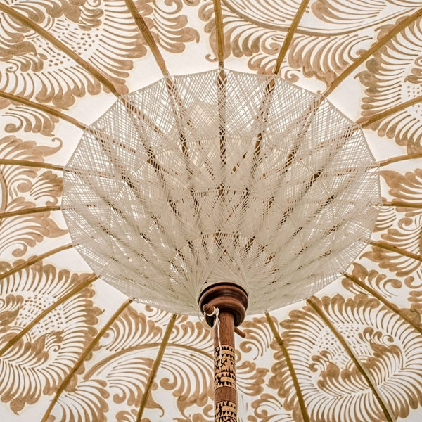 Simone Bamboo Parasol Product shot - White canopy with gold hand painted lotus design, and white tassles