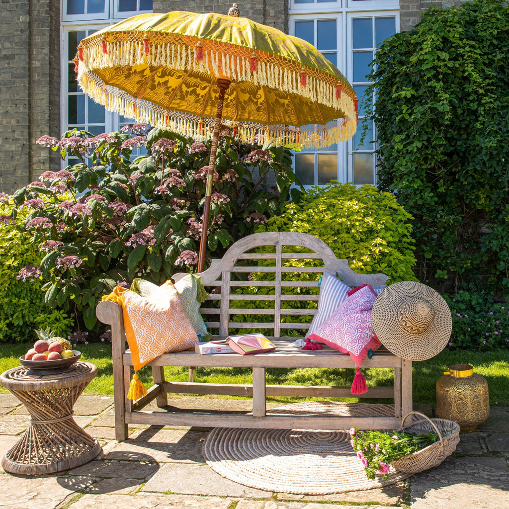 Wolfie Bamboo Parasol basking in the sun with cushion and chairs